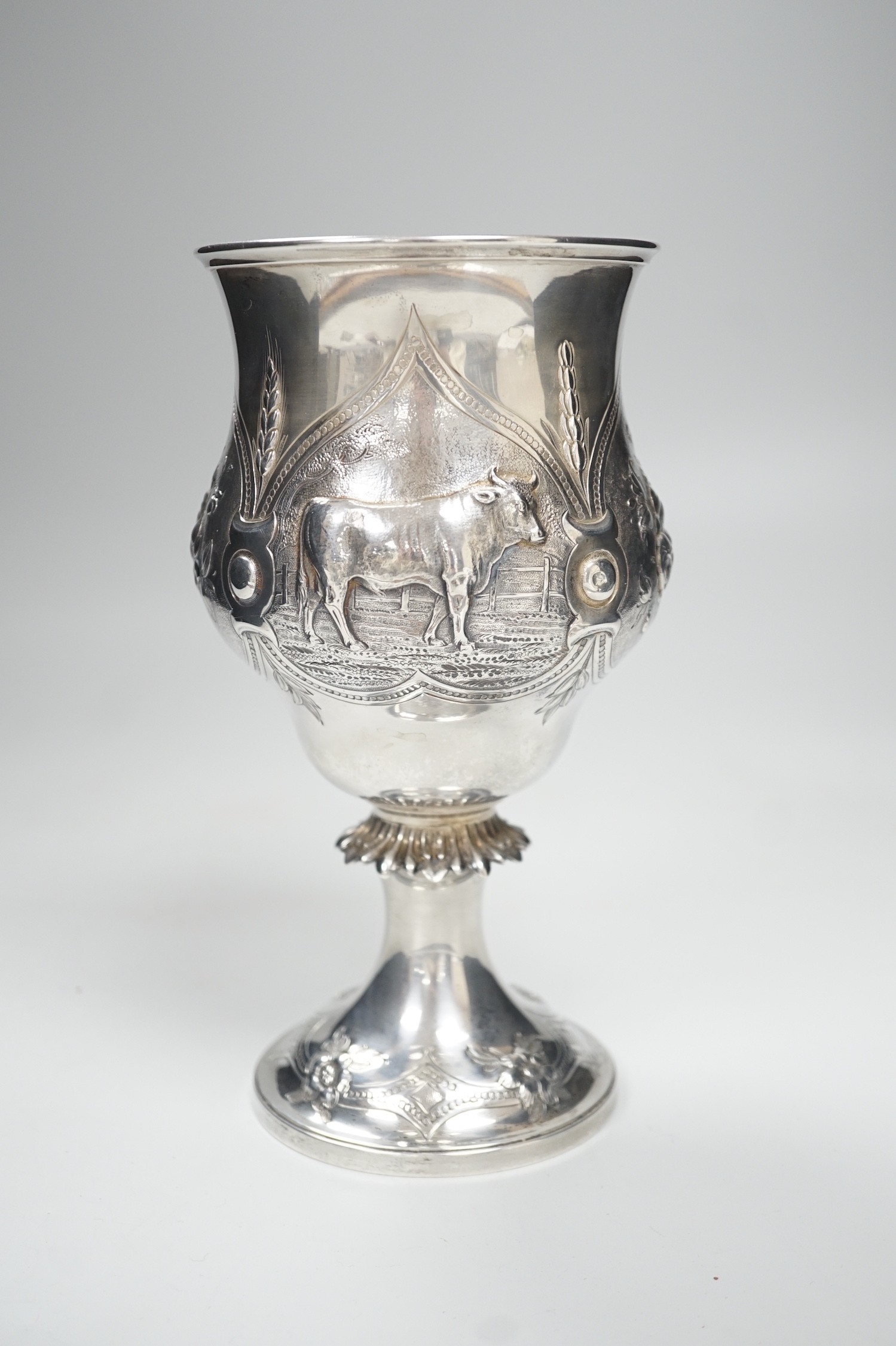 A Victorian silver presentation pedestal cup, embossed with a bull, with later engraved inscription, Edward & John Barnard, London, 1863, 21cm, 13.1 oz.